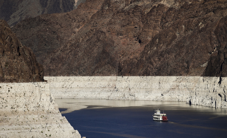 FILE - In this Oct. 14, 2015, file photo, a riverboat glides through Lake Mead on the Colorado River at Hoover Dam near Boulder City, Nev. Despite drought, cities in the U.S. West expect their populations to grow considerably in the coming decades. From Phoenix to Boise, officials are working to ensure they have the resources, infrastructure and housing supply to meet growth projections. In certain parts of the region, their efforts are constrained by the fact that sprawling metro areas are surrounded by land owned by the federal government. U.S. Sen. Catherine Cortez Masto wants to remedy the issue in Las Vegas by strengthening protections for some public lands while approving the sale of others to commercial and residential developers. (AP Photo/Jae C.