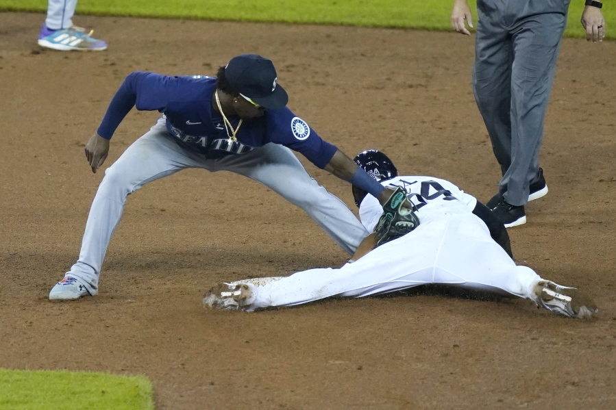 Detroit Tigers' Derek Hill safely beats the tag of Seattle Mariners second baseman Shed Long Jr. for a steal during the fifth inning of a baseball game, Tuesday, June 8, 2021, in Detroit.