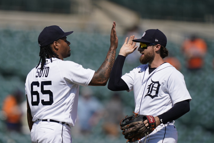 Detroit Tigers relief pitcher Gregory Soto (65) greets left fielder Eric Haase after the team's 8-3 win over the Seattle Mariners in a baseball game, Thursday, June 10, 2021, in Detroit.