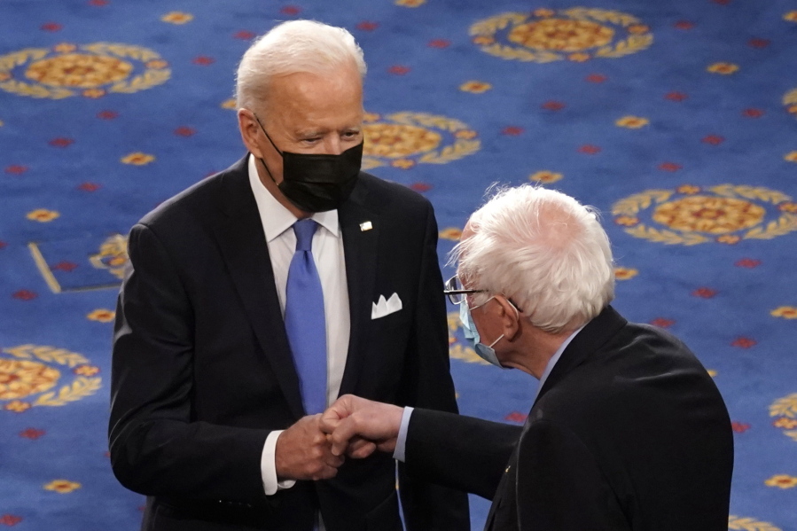 FILE - In this April 28, 2021 file photo, President Joe Biden greets Sen. Bernie Sanders, I-Vt., as Biden arrives to speak to a joint session of Congress  in the House Chamber at the U.S. Capitol in Washington. Many working-age people assume that Medicare covers just about every kind of health care that an older person may need. But it doesn't. Some of the biggest gaps involve dental, vision and hearing services. Now Democrats are trying to make those benefits a standard part of Medicare under massive legislation expected later this year to advance President Joe Biden's domestic agenda. Vermont Independent Sen. Bernie Sanders and other progressives are leading the push.