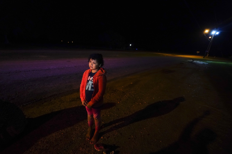 Nine-year-old Emely stands alone after turning herself in at the U.S.-Mexico border in La Joya, Texas, on May 13.