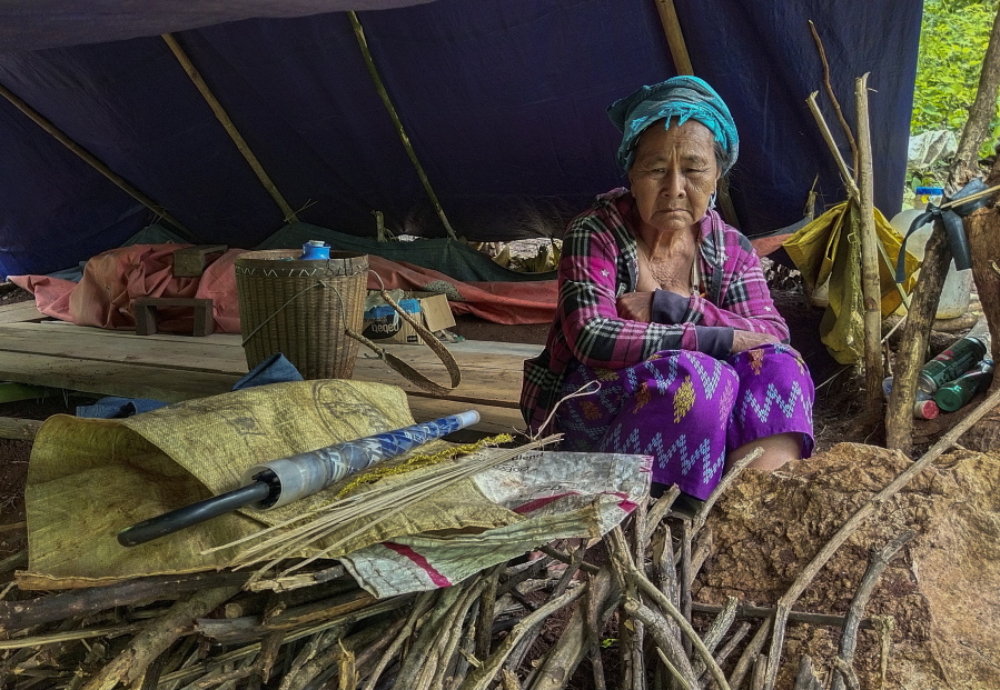 An internally displaced woman sits inside her makeshift tent Thursday at Pu Phar Village, Demawso Township, Kayah State.
