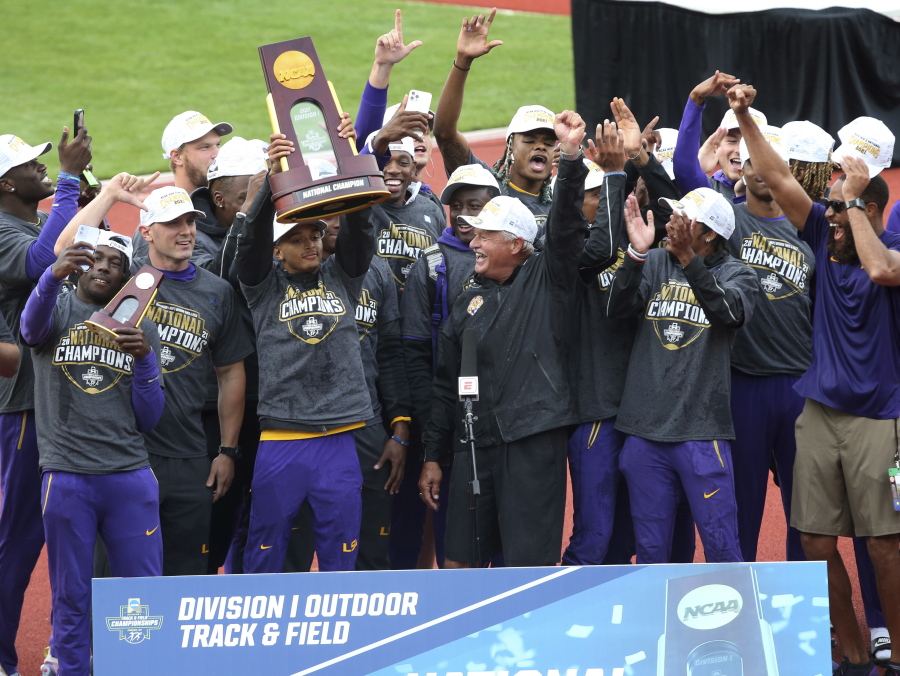 LSU athletes and coach Dennis Shaver, center, celebrate after LSU won the men's team title at the NCAA Outdoor Track and Field Championship in Eugene, Ore., Friday, .June 11, 2021.