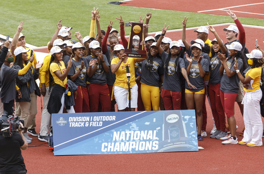 The Southern California women's team accepts the team trophy at the NCAA Division I Outdoor Track and Field Championships, Saturday, June 12, 2021, at Hayward Field in Eugene, Ore.