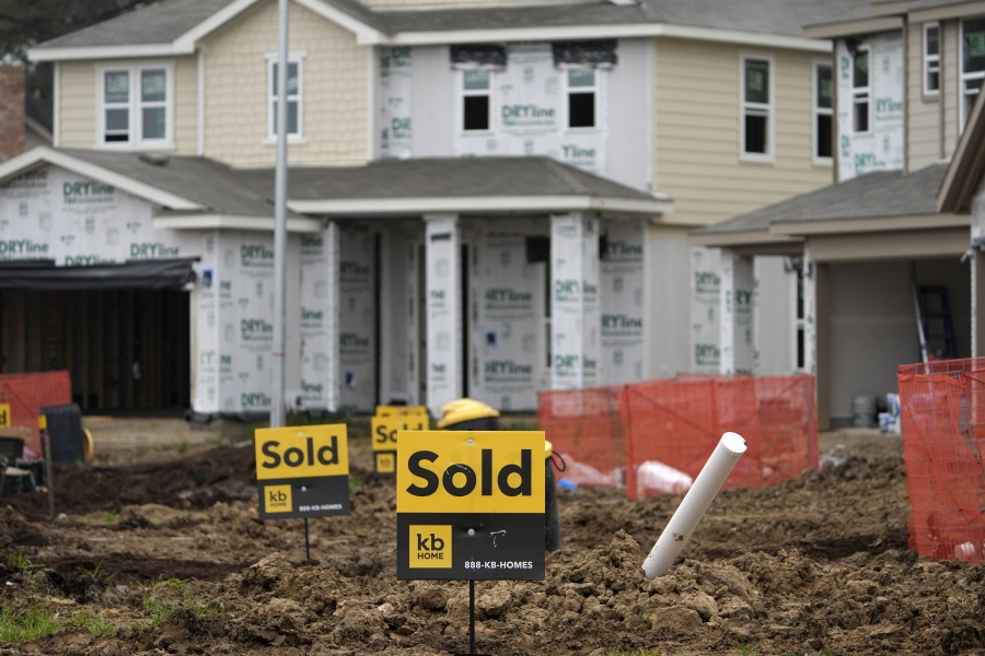 Sold signs stand in front of new homes under construction Monday, March 15, 2021, in Houston.  Sales of new homes fell a bigger-than-expected 5.9% in April, a drop that analysts blamed in part on soaring home prices.  (AP Photo/David J.