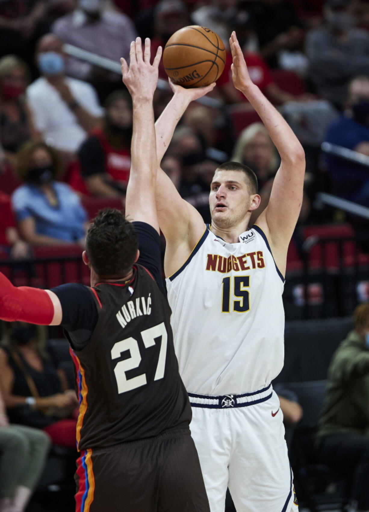 Denver Nuggets center Nikola Jokic shoots over Portland Trail Blazers center Jusuf Nurkic during the first half of Game 6 of an NBA basketball first-round playoff series Thursday, June 3, 2021, in Portland, Ore.