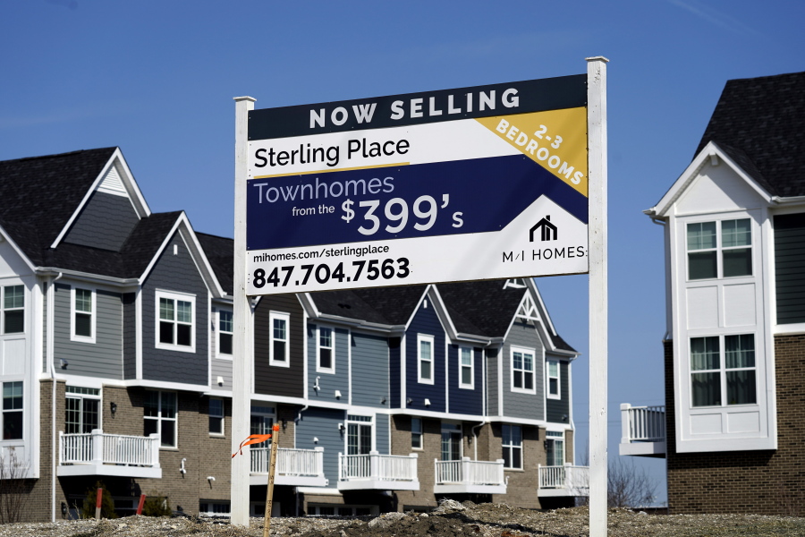 An advertising sign for building land stands in front of a new home construction site in Northbrook, Ill., Sunday, March 21, 2021.  The red-hot U.S. housing market is widening the gap between what a home is objectively worth and what eager buyers are willing to pay for it. Fierce competition amid an ultra-low inventory of homes on the market is fueling bidding wars, prompting a growing share of would-be buyers to sweeten offers well above what sellers are asking.   (AP Photo/Nam Y.