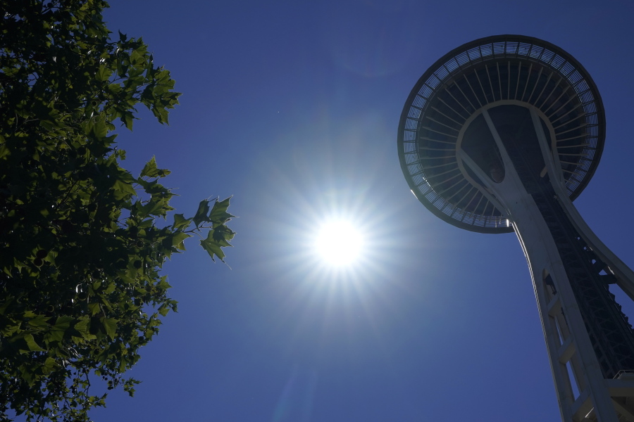 The sun shines near the Space Needle, Monday, June 28, 2021, in Seattle. Seattle and other cities broke all-time heat records over the weekend, with temperatures soaring well above 100 degrees Fahrenheit (37.8 Celsius). (AP Photo/Ted S.
