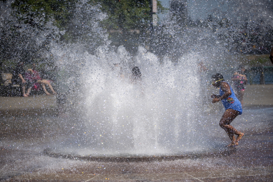 While Portland reached a record temperature of over 110 degrees Sunday, June 27, 2021 people gathered at Salmon Street Springs water fountain in Portland to cool off.