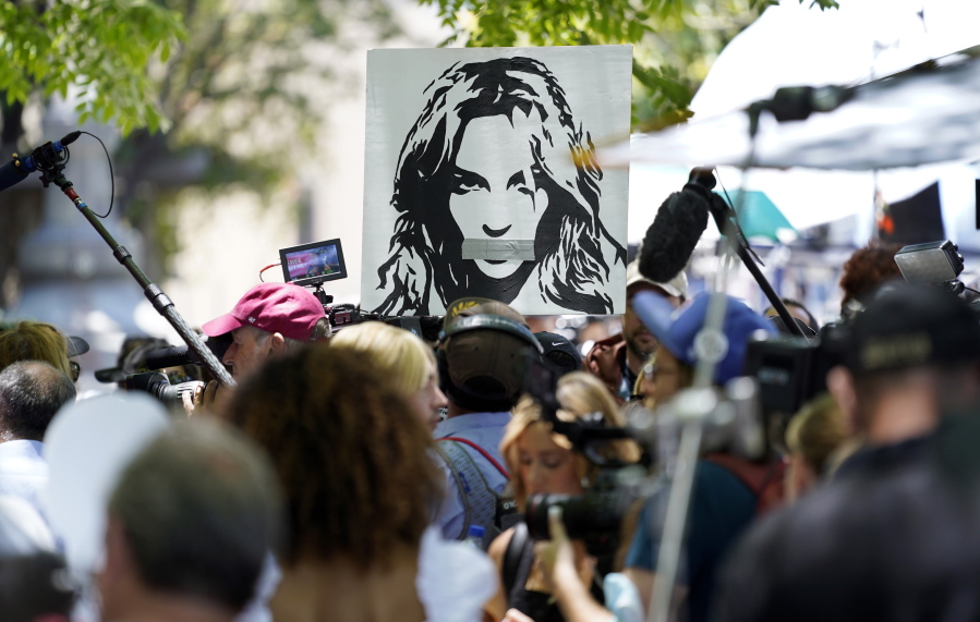 A portrait of Britney Spears looms over supporters and media members outside a court hearing concerning the pop singer's conservatorship at the Stanley Mosk Courthouse, Wednesday, June 23, 2021, in Los Angeles.