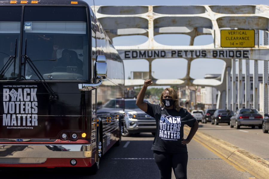 LaTosha Brown, co-founder of Black Voters Matter, stands atop the Edmund Pettus Bridge, a famous civil rights landmark, Saturday, May 8, 2021, in Selma, Ala. Brown was a keynote speaker at the John Lewis Advancement Act Day of Action, a voter education and engagement event held in Selma and Montgomery.