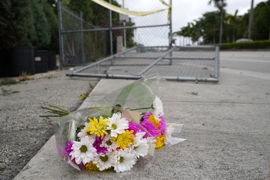 Flowers lie at the scene where a driver slammed into spectators at the start of a Pride parade Saturday evening, killing one man and seriously injuring another, Sunday, June 20, 2021, in Fort Lauderdale, Fla. Officials said the crash was an accident, but it initially drew speculation that it was a hate crime directed at the gay community. The driver and victims were all members of the Fort Lauderdale Gay Men's Chorus, who were participating in the Wilton Manors Stonewall Pride Parade.
