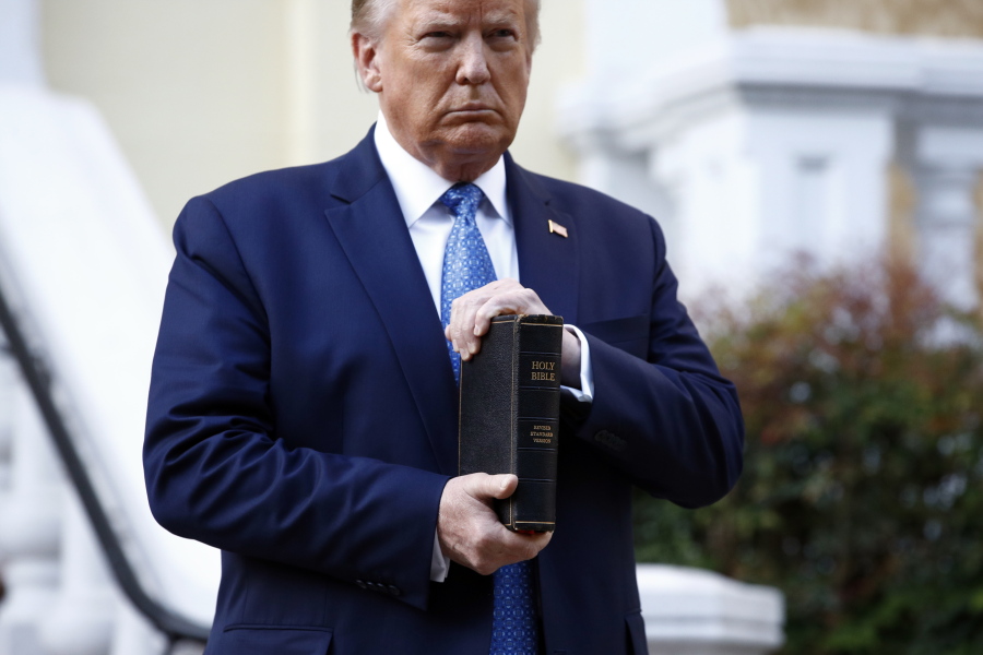 FILE- In this June 1, 2020, file photo President Donald Trump holds a Bible as he visits outside St. John's Church across Lafayette Park from the White House in Washington.