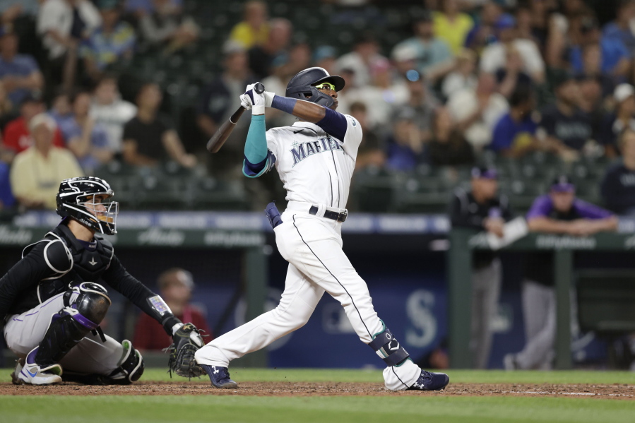 Seattle Mariners' Shed Long Jr. hits a solo home run on a pitch from Colorado Rockies' Tyler Kinley during the eighth inning of a baseball game, Tuesday, June 22, 2021, in Seattle.