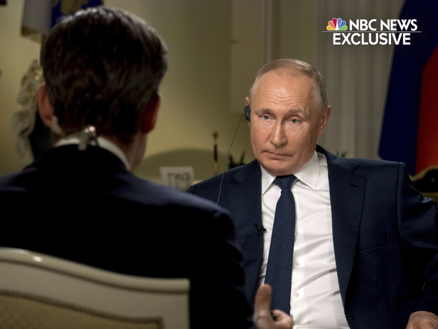 In this image provided by NBC News, Keir Simmons, left, speaks with Russian President Vladimir Putin in an interview aired on Monday, June 14, 2021, two days before the Russian leader is to meet U.S. President Joe Biden in Geneva. Putin has sharply dismissed allegations that his country is carrying out cyberattacks against the United States as baseless.