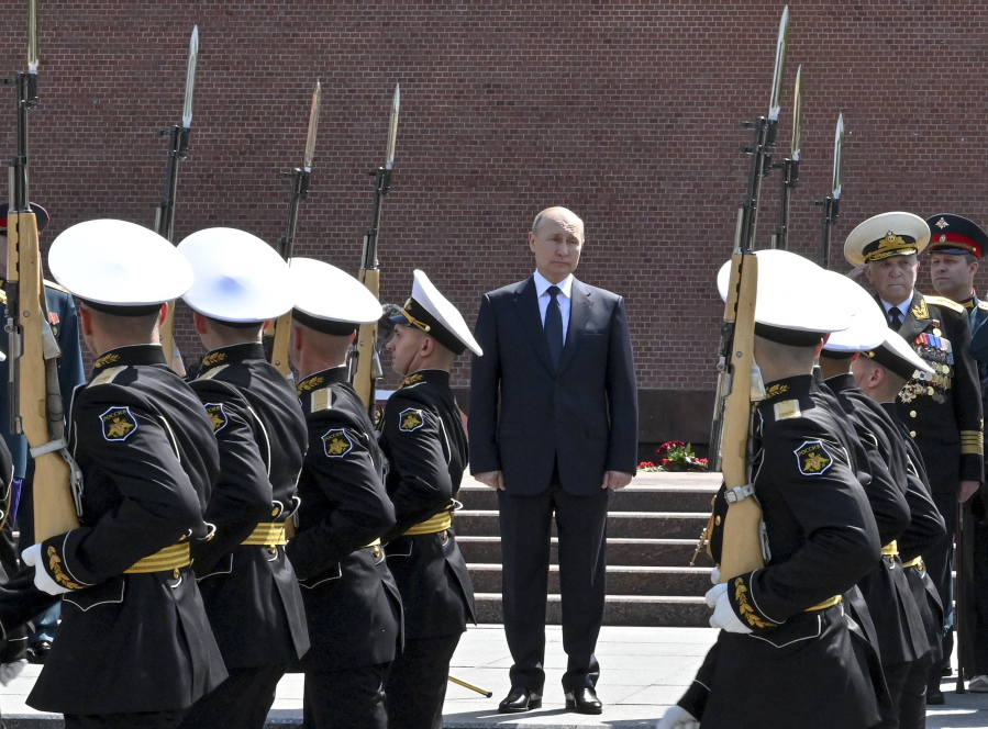 Russian President Vladimir Putin attends a ceremony in memory of those killed during WWII as he takes part in a wreath laying ceremony at the Tomb of Unknown Soldier in Moscow, Russia, Tuesday, June 22, 2021, marking the 80th anniversary of the Nazi invasion of the Soviet Union.