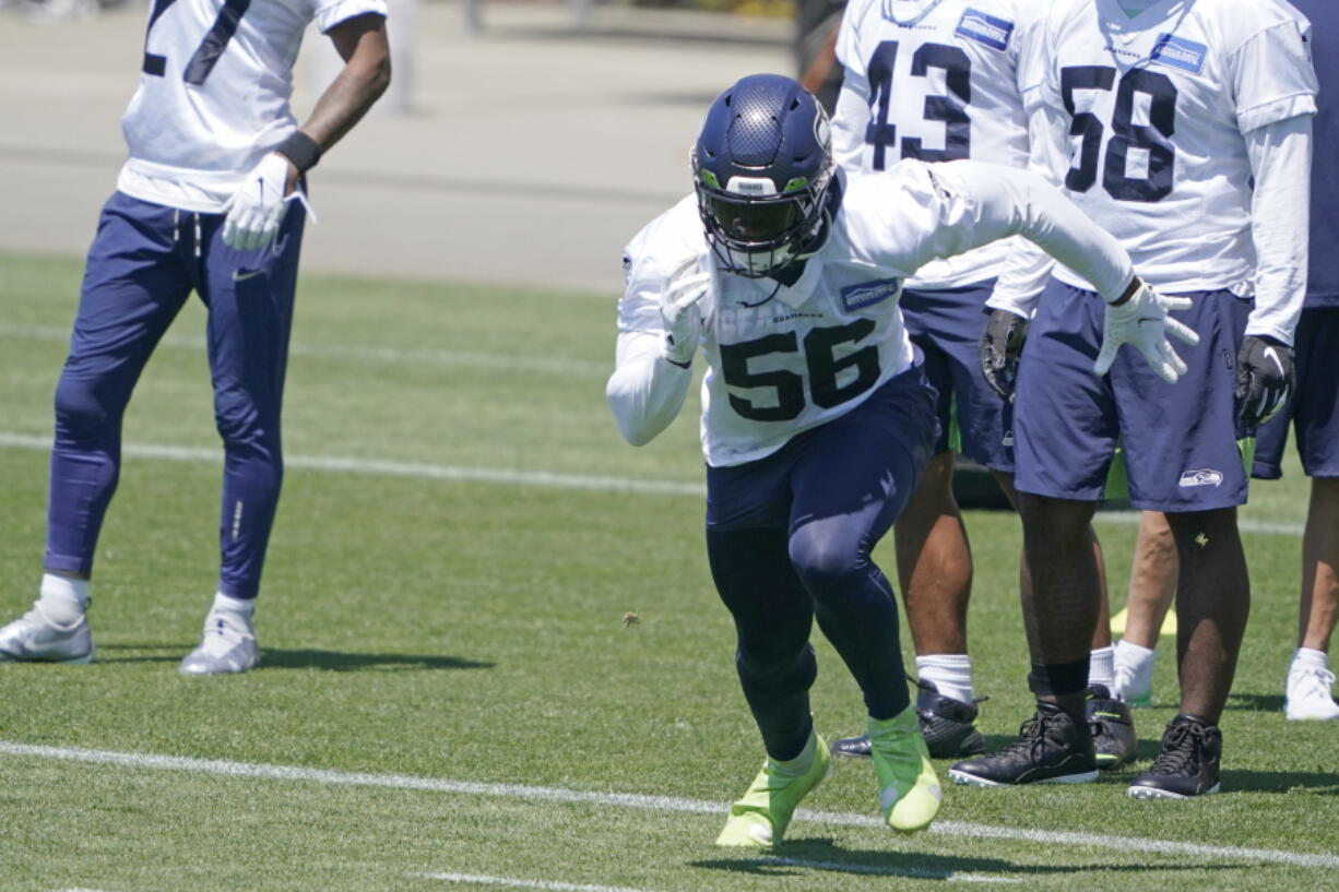 Seattle Seahawks linebacker Jordyn Brooks (56) runs a drill during NFL football practice Wednesday, June 16, 2021, in Renton, Wash. (AP Photo/Ted S.