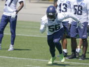Seattle Seahawks linebacker Jordyn Brooks (56) runs a drill during NFL football practice Wednesday, June 16, 2021, in Renton, Wash. (AP Photo/Ted S.