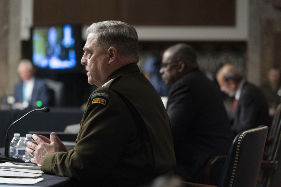 From left, Chairman of the Joint Chiefs of Staff Gen. Mark Milley, accompanied by Secretary of Defense Lloyd Austin, and Defense Under Secretary Mike McCord, speaks at a Senate Armed Services budget hearing on Capitol Hill in Washington, Thursday, June 10, 2021.