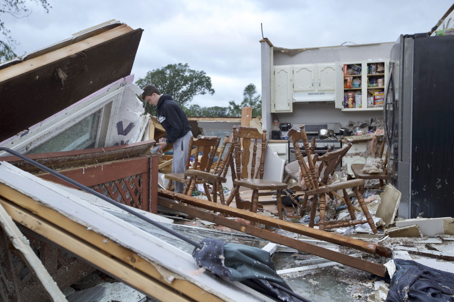 Nathan Casey, 16, surveys the damage of his home after a tornado swept through the area in Woodridge, Ill., Monday June 21, 2021.