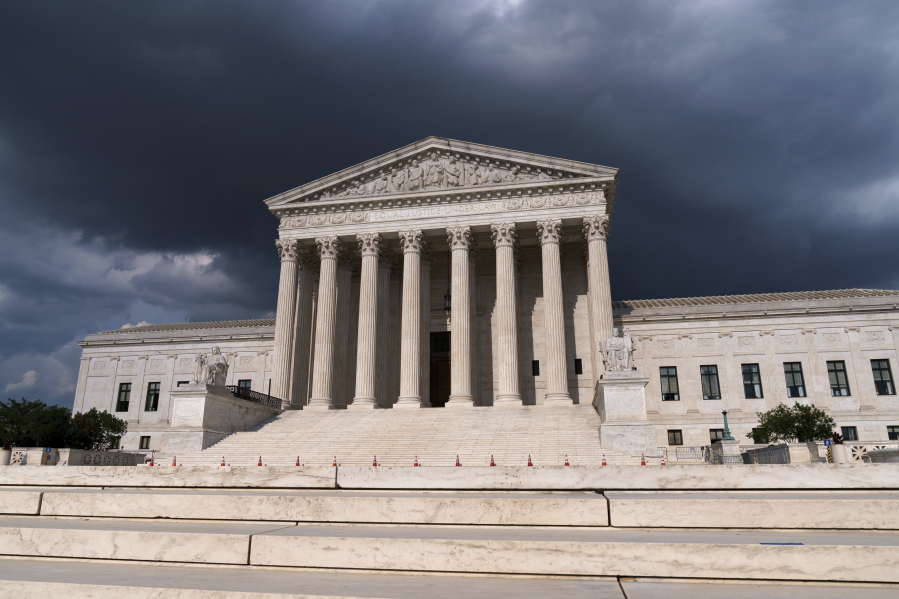 In this June 8, 2021 photo, with dark clouds overhead, the Supreme Court is seen in Washington. (AP Photo/J.
