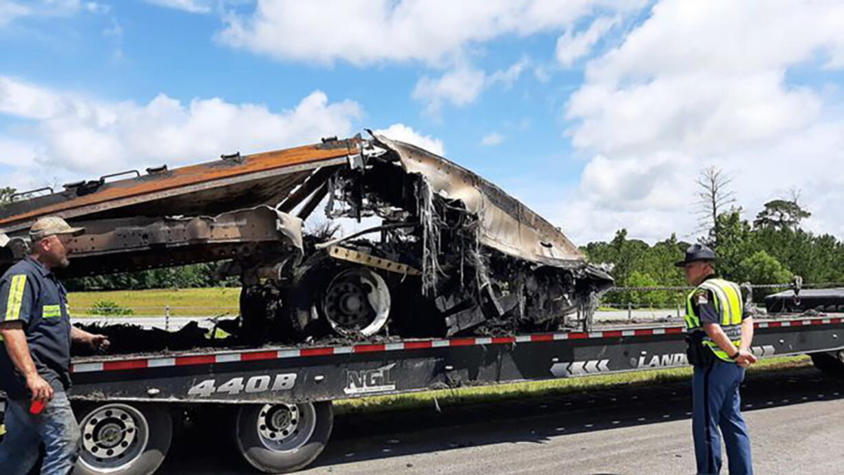 Some of the wreckage from a fatal multiple-vehicle crash a day earlier is loaded to be carried away, Sunday, June 20, 2021, in Butler County, Ala.