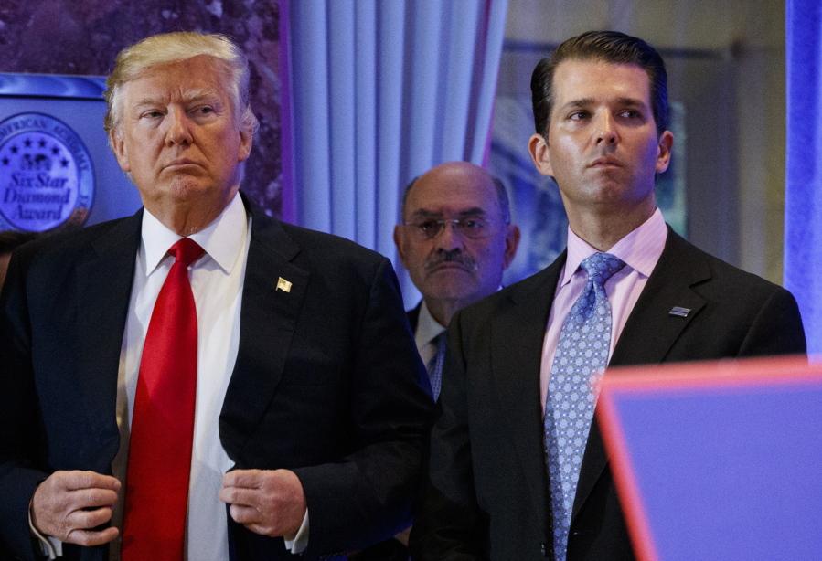 FILE - In this Jan. 11, 2017, shows President-elect Donald Trump, left, his chief financial officer Allen Weisselberg, center, and his son Donald Trump Jr., right, attend a news conference in the lobby of Trump Tower in New York. Manhattan prosecutors have informed Donald Trump's company that it could soon face criminal charges stemming from a long-running investigation into the former president's business dealings. The New York Times reported that charges could be filed against the Trump Organization as early as next week related to fringe benefits the company gave to top executives, such as use of apartments.