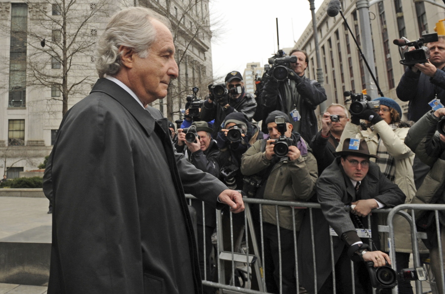FILE - Bernard Madoff exits Manhattan federal court, Tuesday, March 10, 2009, in New York. The epic Ponzi scheme mastermind  is dead. But the effort to untangle his web of deceit lives on.