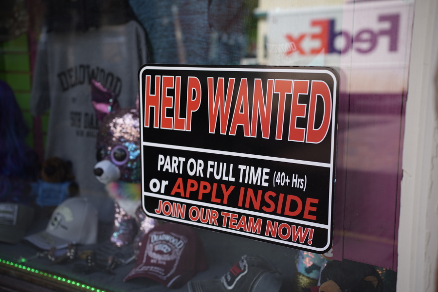 In this May 26, 2021 photo, a sign for workers hangs in the window of a shop along Main Street in Deadwood, S.D. U.S. employers added 559,000 jobs in May, an improvement from April's sluggish gain but still evidence that many companies are struggling to find enough workers as the economy rapidly recovers from the pandemic recession.