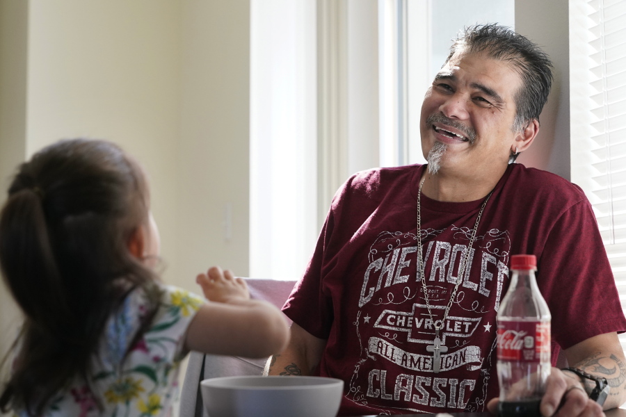 Leroy Pascubillo smiles as he looks at his daughter, who was born addicted to heroin and placed with a foster family at birth, and talks about his journey regaining custody, May 10, 2021, in Seattle. Pascubillo, who had used drugs for the better part of four decades, was in a court-ordered in-patient drug rehab program when the pandemic first hit.
