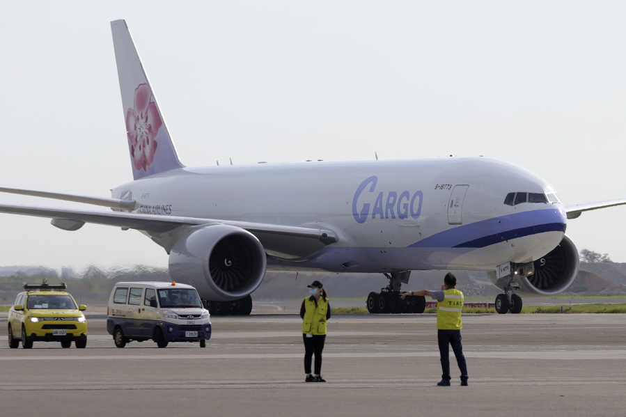 In this photo released by the Taiwan Centers for Disease Control, a China Airlines cargo plane carrying COVID-19 vaccines from Memphis arrive at the airport outside Taipei, Taiwan, Sunday, June 20, 2021. The U.S. sent 2.5 million doses of the Moderna COVID-19 vaccine to Taiwan on Sunday, tripling an earlier pledge in a donation with both public health and geopolitical meaning.