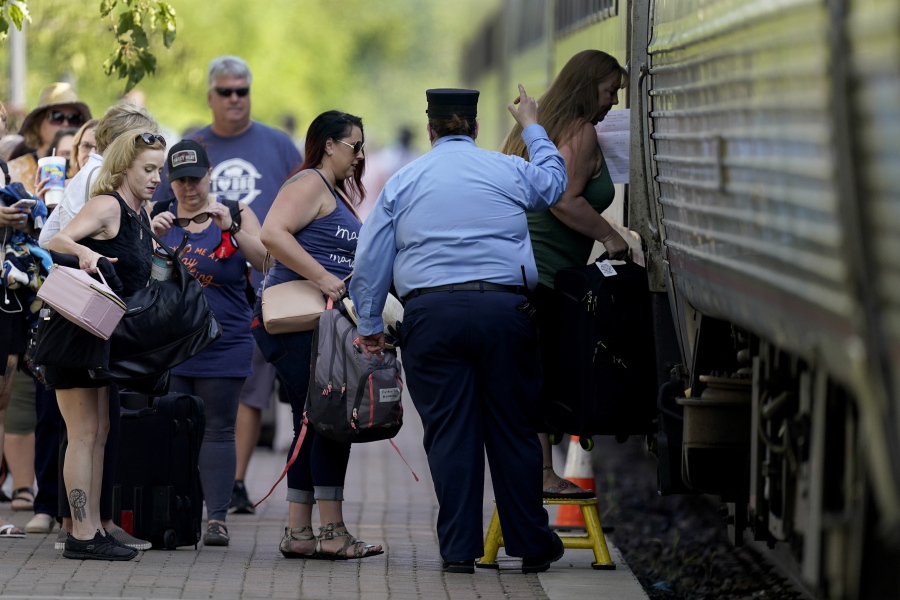 FILE - In this June 11, 2021, file photo, passengers board a Missouri River Runner Amtrak train in Lee's Summit, Mo. As the U.S. emerges from the COVID-19 crisis, Missouri is becoming a cautionary tale for the rest of the country: It is seeing an alarming rise in cases because of a combination of the fast-spreading delta variant and stubborn resistance among many people to getting vaccinated.
