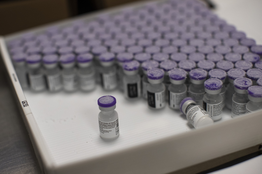 FILE - In this Monday, Jan. 4, 2021 file photo, frozen vials of the Pfizer/BioNTech COVID-19 vaccine are taken out to thaw, at the MontLegia CHC hospital in Liege, Belgium. The U.S. will buy 500 million more doses of the Pfizer COVID-19 vaccine to share through the COVAX alliance for donation to 92 lower income countries and the African Union over the next year, a person familiar with the matter said Wednesday. President Joe Biden was set to make the announcement Thursday in a speech before the start of Group of Seven summit.