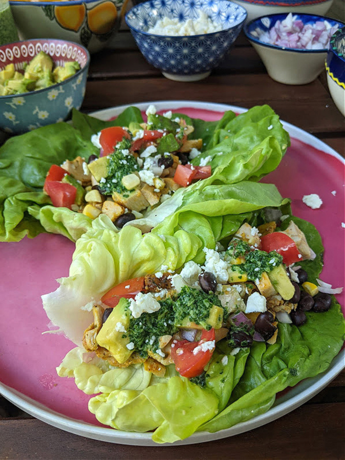Chicken taco lettuce cups are a hand-held take on the popular Mexican 7-layer dip served at parties.