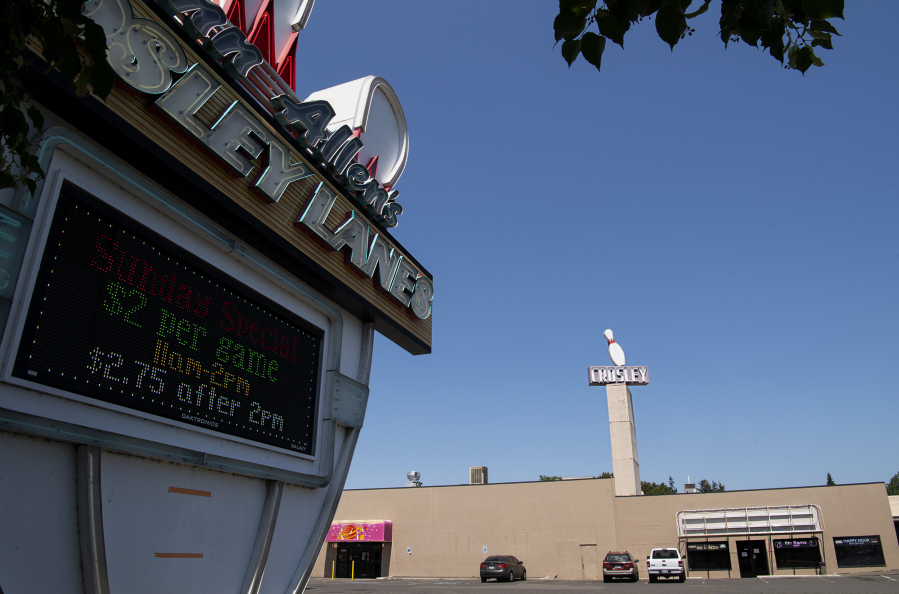 The Crosley Lanes sign flashes and spins on Tuesday in Vancouver. Owners Don and Rachel Allen plan to retire and sell the property to a developer who intends to build a five-story apartment complex on the site.