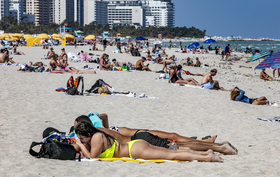 Beachgoers on South Beach on March 2, 2021. States who rely heavily on international tourists have been hit hard during the pandemic.