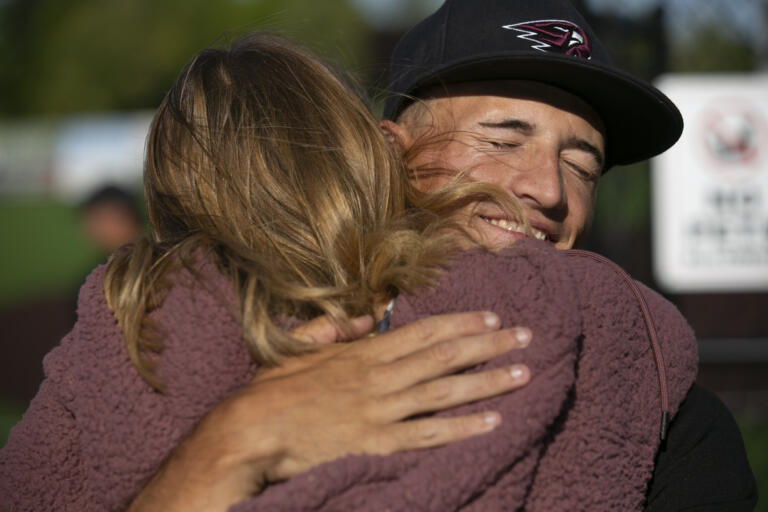 Eli Shubert, pitcher for the Ridgefield Raptors, hugs his mom Vicky Shubert after marrying Erin Thum in a short ceremony on the field before a game against the Port Angeles Lefties at Ridgefield Outdoor Recreation Complex on Wednesday, July 14, 2021.