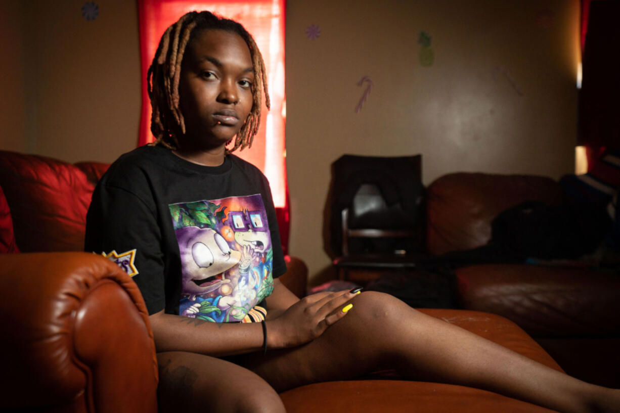 Wilberte Moise, shown here in her home in Philadelphia, is a former Amazon worker who tore a ligament in her knee in 2018 when trying to pick up a heavy package in the King of Prussia facility. Moise said she elevates her knee when resting because it is more comfortable.