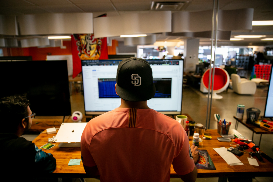 Software engineers Adrian Eufracio, right, and Digant Jagtap work together at Zeeto, an internet marketing company, on Tuesday, May 28, 2019 in San Diego, California.