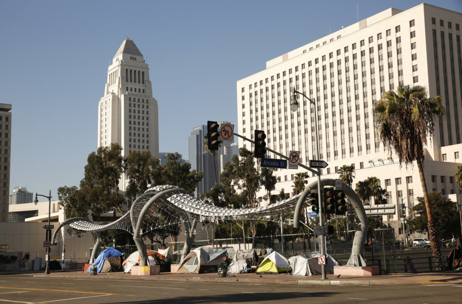 Homeless people erected tents along Los Angeles Street over the 101 Freeway on Friday, November 13, 2020 in Los Angeles.