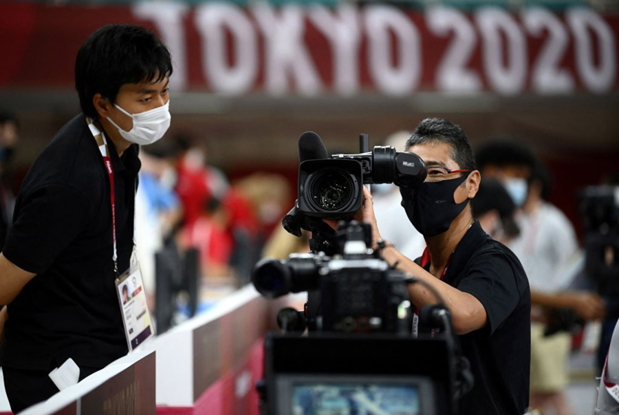 A TV host cameraman checks his camera Wednesday inside the Nippon Budokan venue for judo and karate events during the Tokyo 2020 Olympic Games in Tokyo.
