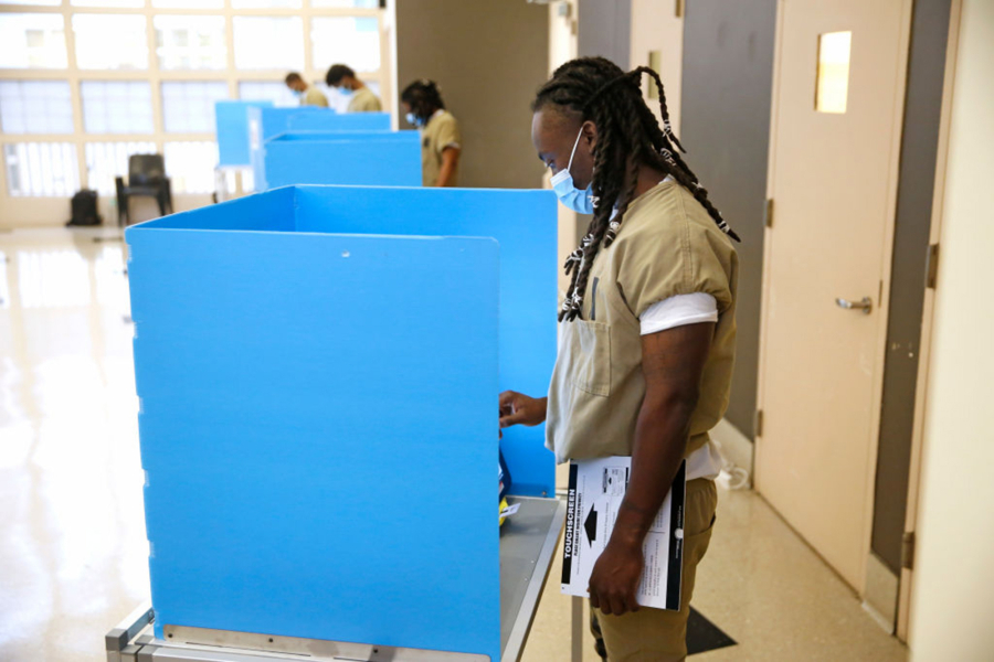 A Cook County jail detainee uses a touch screen to cast his votes at a polling place in the facility set up for early voting on October 17, 2020 in Chicago, Illinois.