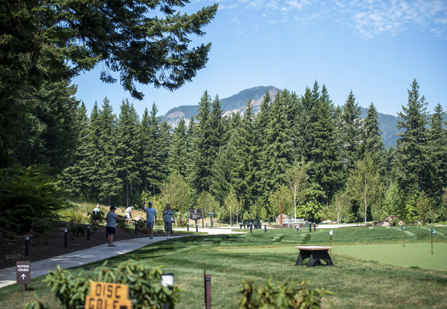 Patrons walk around the new 18-hole putting course Wednesday at Skamania Lodge in Stevenson. The course replaces the old driving range and was paired with a project that remodeled the full 18-hole course into a nine-hole course for faster games.