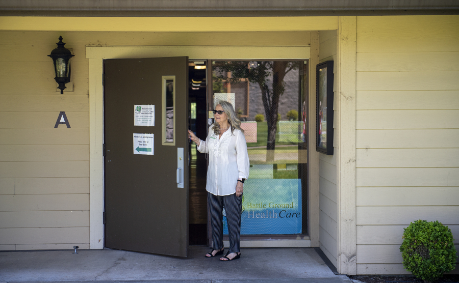 Executive director Sue Neal of Battle Ground Health Care looks out the front door of the current facility in Meadow Glad. The clinic was recently awarded a $1.1 million community development block grant to purchase a new, bigger building in a more visible location in Battle Ground.
