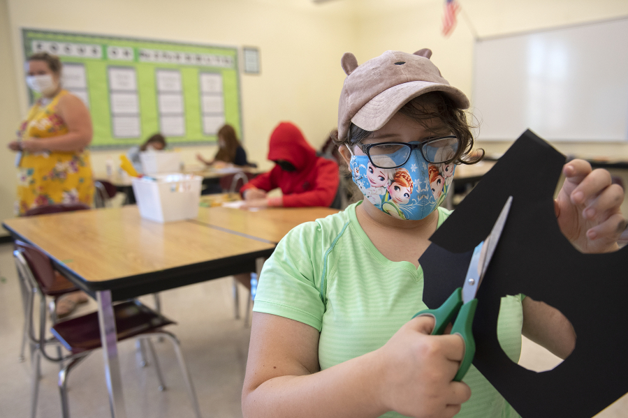 Maddie Ackerman, 13, tackles a project during a summer school art class at Covington Middle School on Tuesday morning. Evergreen Public Schools is expanding summer school offerings to middle school students for the first time, in subjects ranging from algebra readiness to science, plus a host of Social Emotional Learning options.
