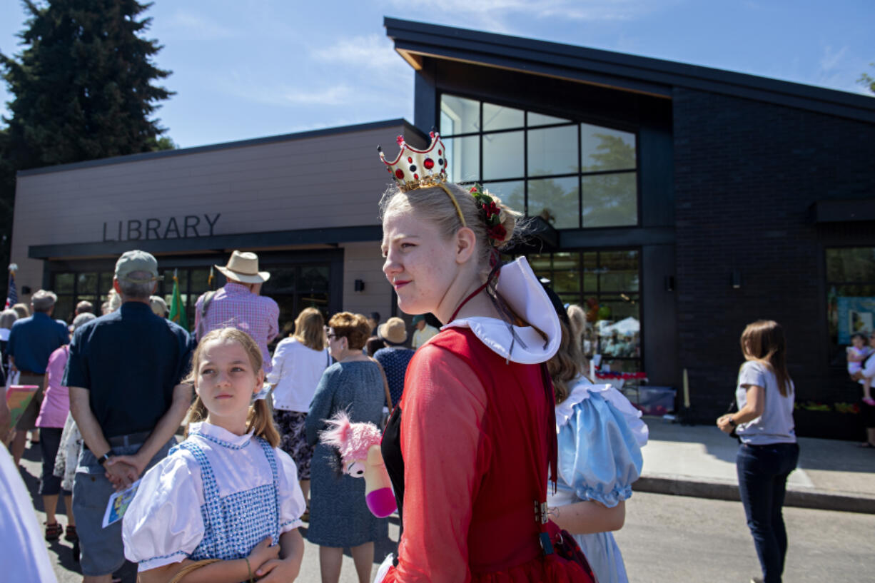 A cast of book characters helped celebrate Friday's grand opening of the new Ridgefield Community Library, including 10-year-old Iris Taylor dressed as Dorothy from the Wizard of Oz, and her sister, Guinevere Taylor, 14, dressed as the Queen of Hearts. About 500 attended the opening of the nearly 8,000-square-foot library at 210 Main Ave. in Ridgefield.