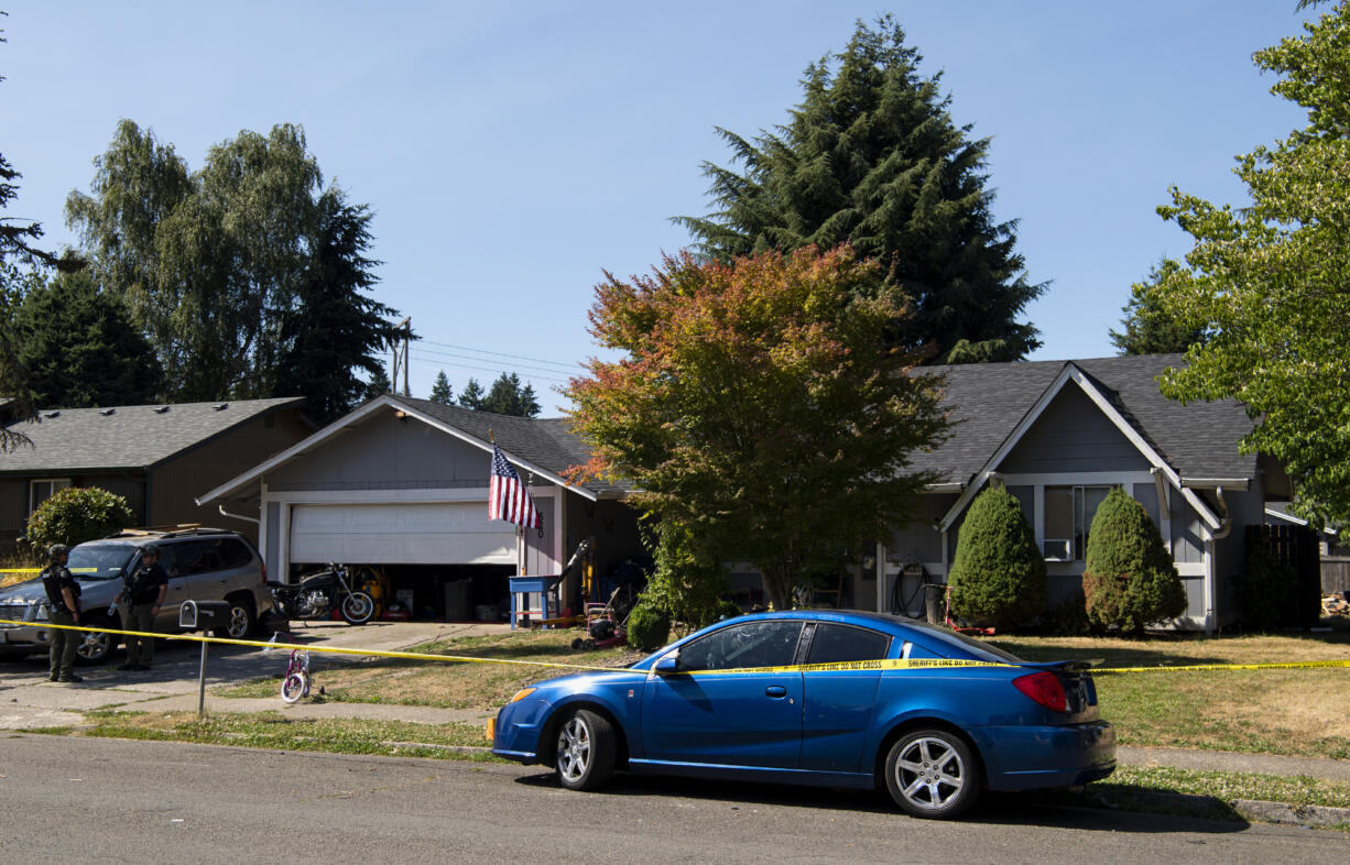 Crime scene tape is around a home at the corner of Northwest 82nd Street and Northwest Sixth Avenue on Tuesday, July 6, 2021, in Hazel Dell.