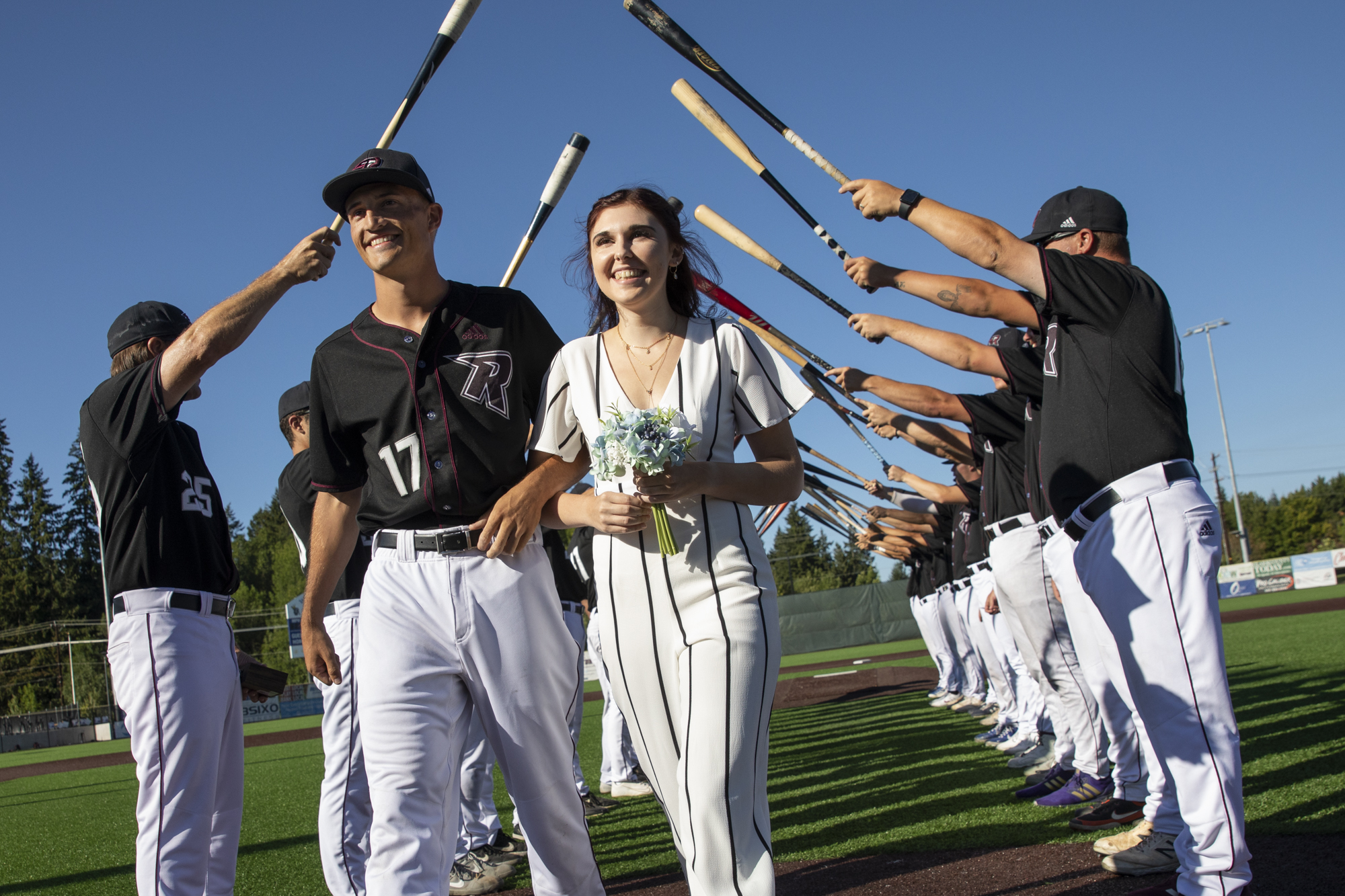 Eli Shubert, pitcher for the Ridgefield Raptors, marries Erin Thum in a short ceremony on the field before a game against the Port Angeles Lefties at Ridgefield Outdoor Recreation Complex on Wednesday, July 14, 2021.