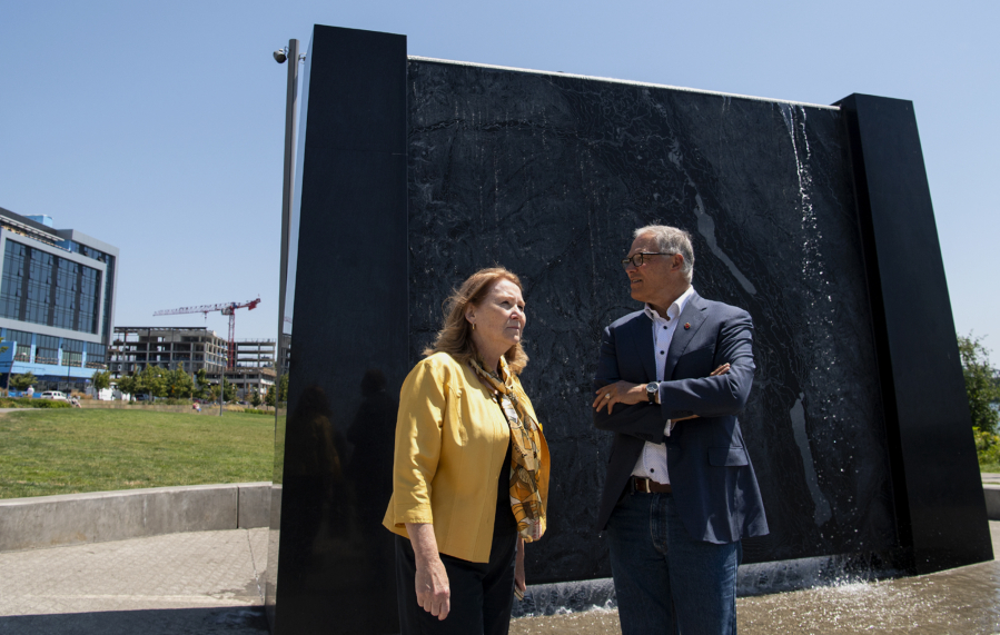 Vancouver Mayor Anne McEnerny-Ogle and Gov. Jay Inslee survey The Waterfront Vancouver while standing in front of an interactive sculpture that depicts the topography of the Columbia River on Tuesday. Inslee toured the waterfront with the mayor before meeting with local small-business owners.