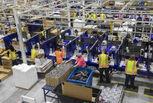 Workers assemble products and packaging on the manufacturing floor at Hawthorne Gardening Company in Vancouver in 2021.